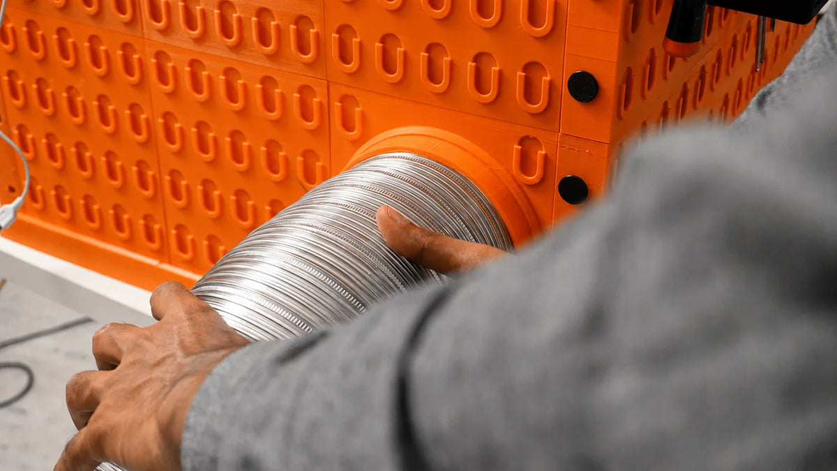 Flexible extraction hose connected to a WorkBox duct adapter; extraction equipment sold separately