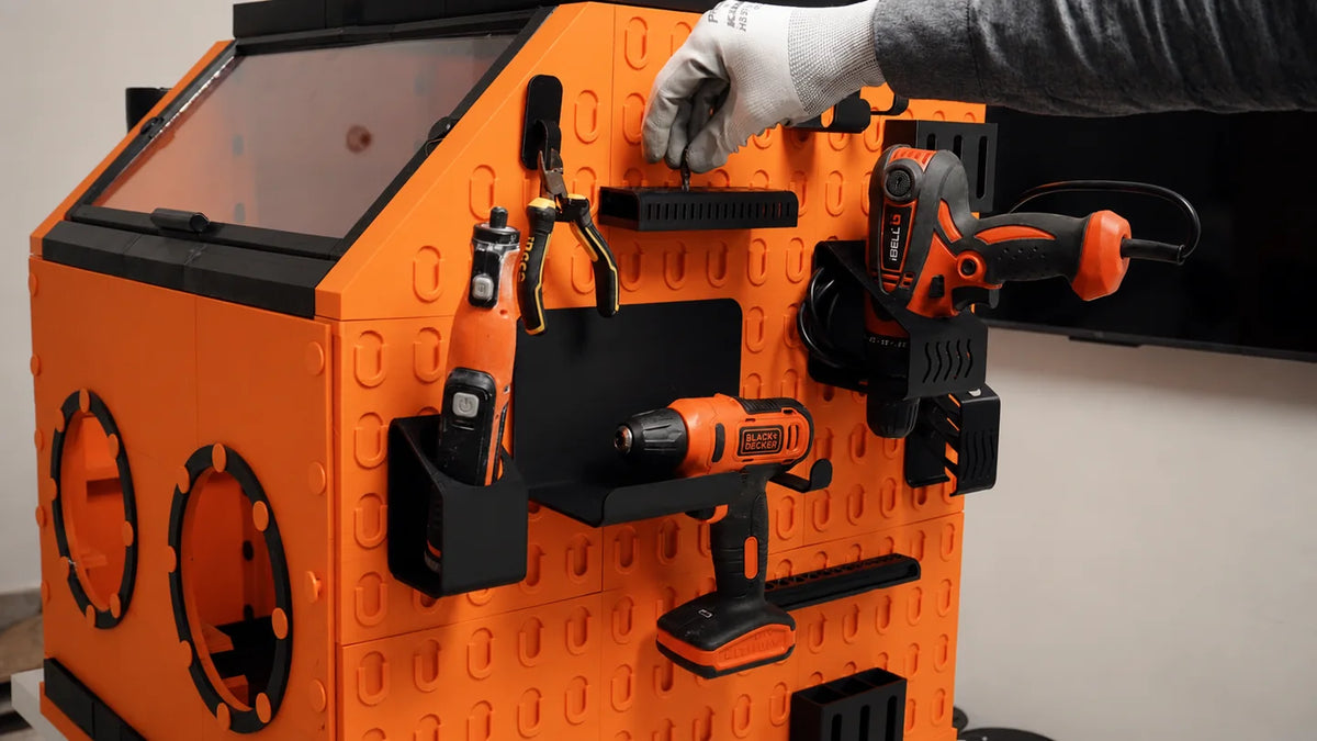 Printed WorkBox holders organize tools on the exterior pegboard wall; tools not included